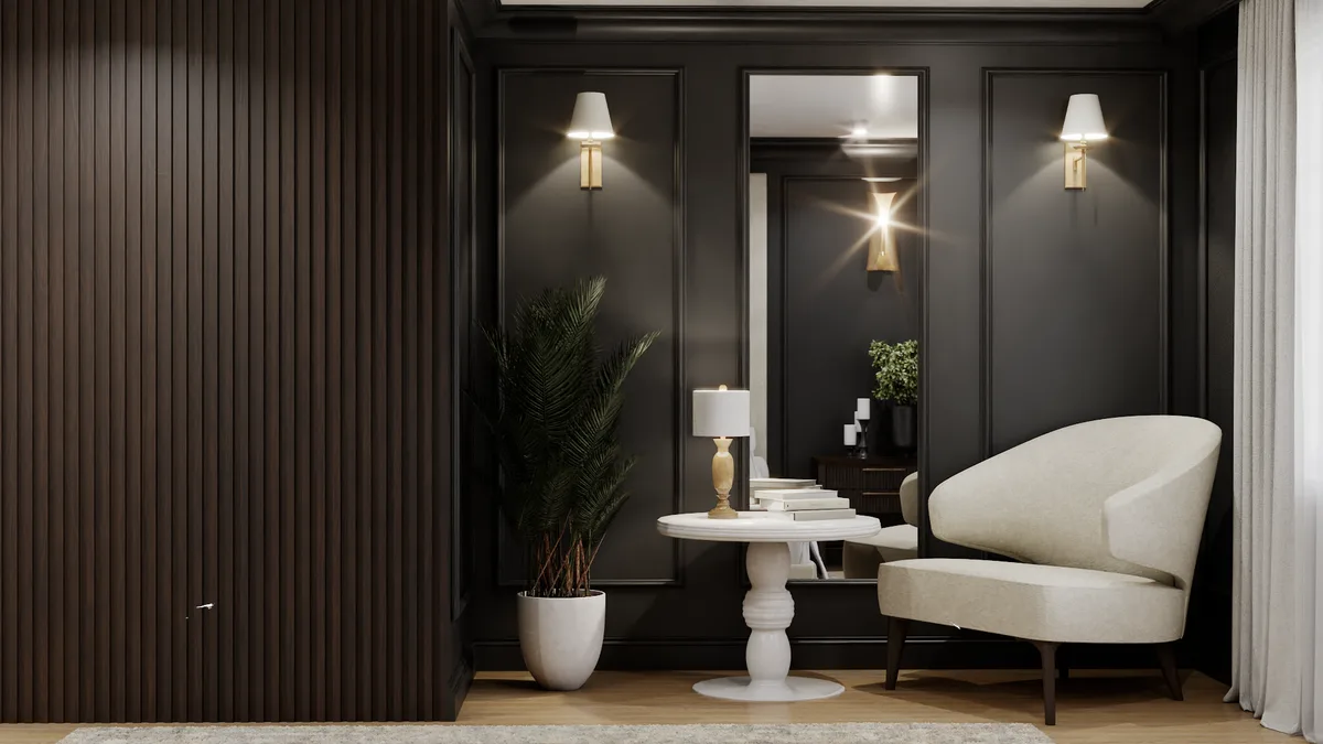 Bedroom sitting nook with dark slat wall, cream barrel chair, and brass sconces flanking mirror