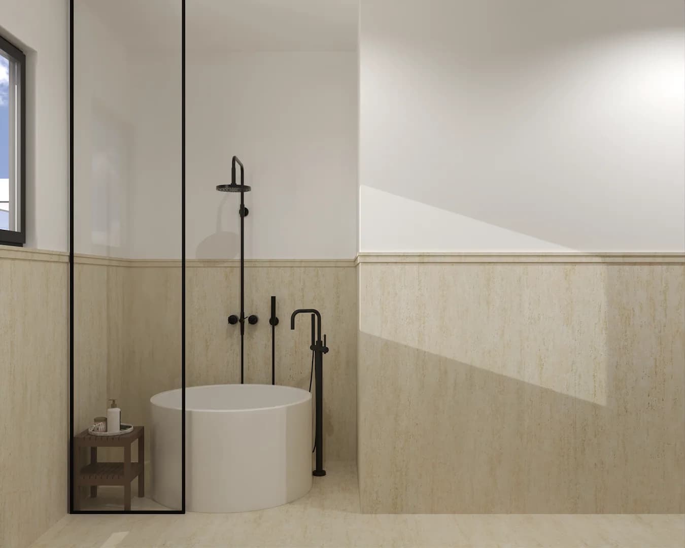 Bathroom with round white freestanding tub, black shower, and travertine wainscot below painted upper walls
