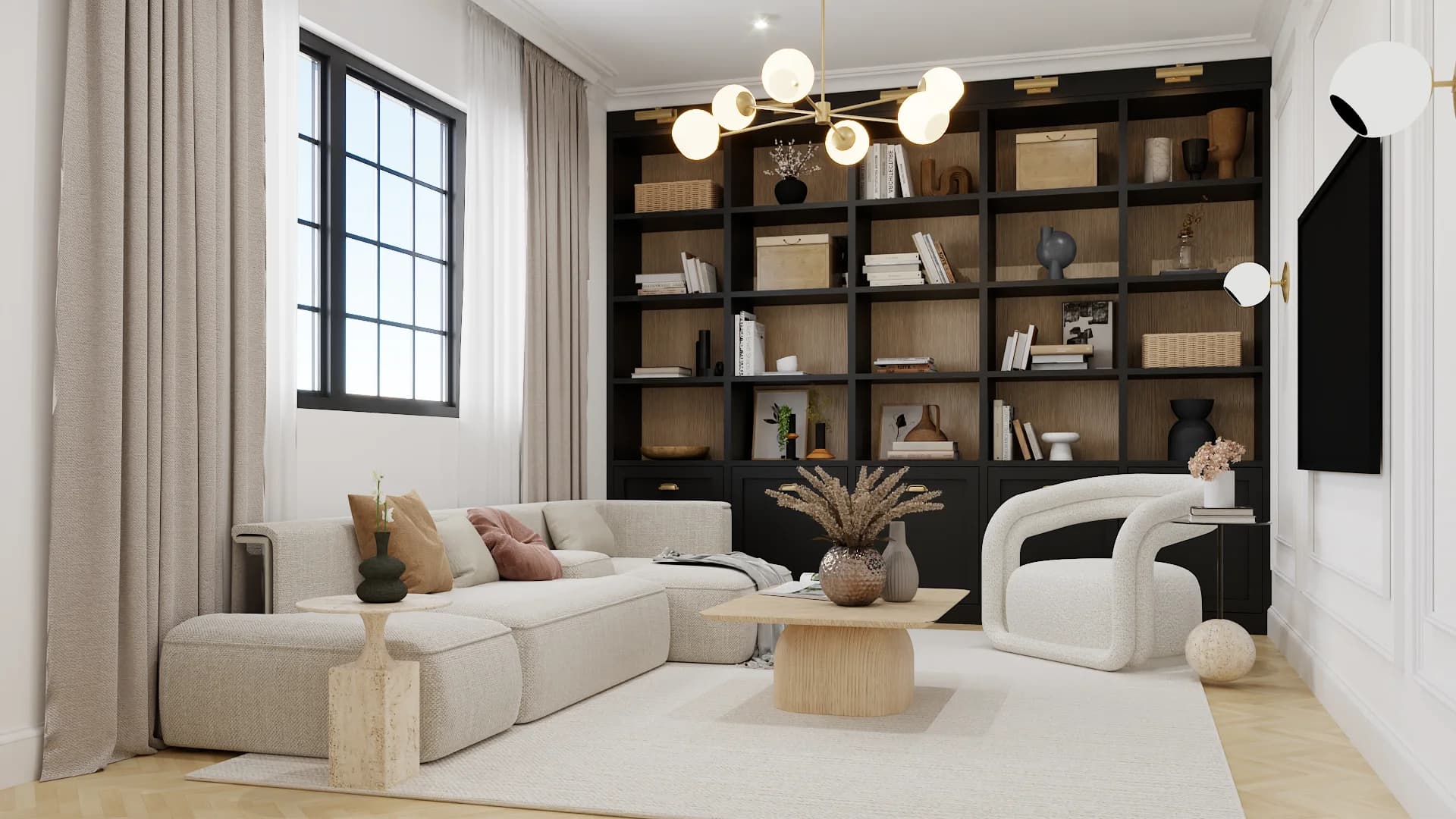 Library lounge with cream sectional, black bookcase wall, brass chandelier, and round wood coffee table