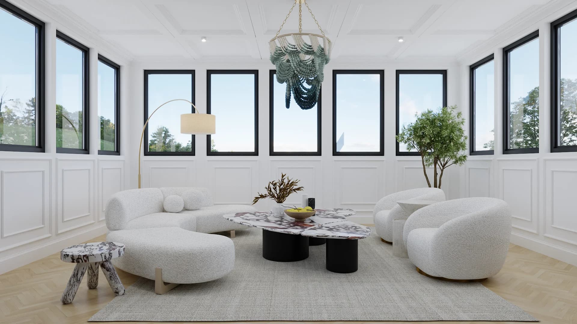 Sunroom with curved white boucle sofas, round black-leg coffee table, and blue capiz chandelier under tall windows