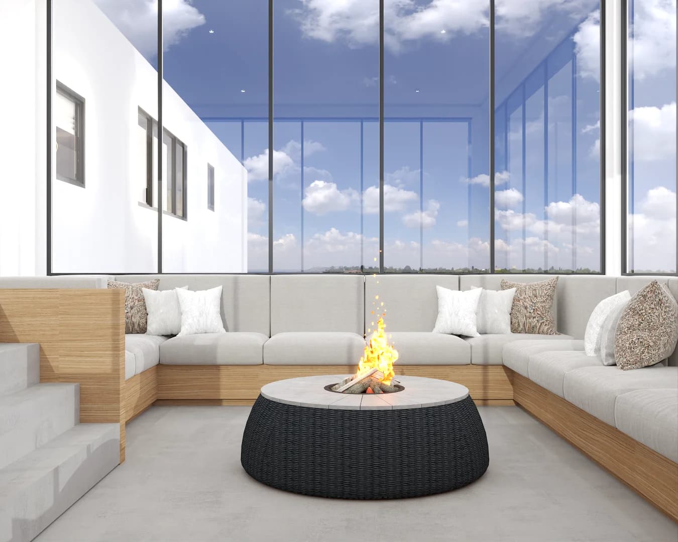 Sunroom fire pit with built-in light wood banquette, cream cushions, and floor-to-ceiling windows