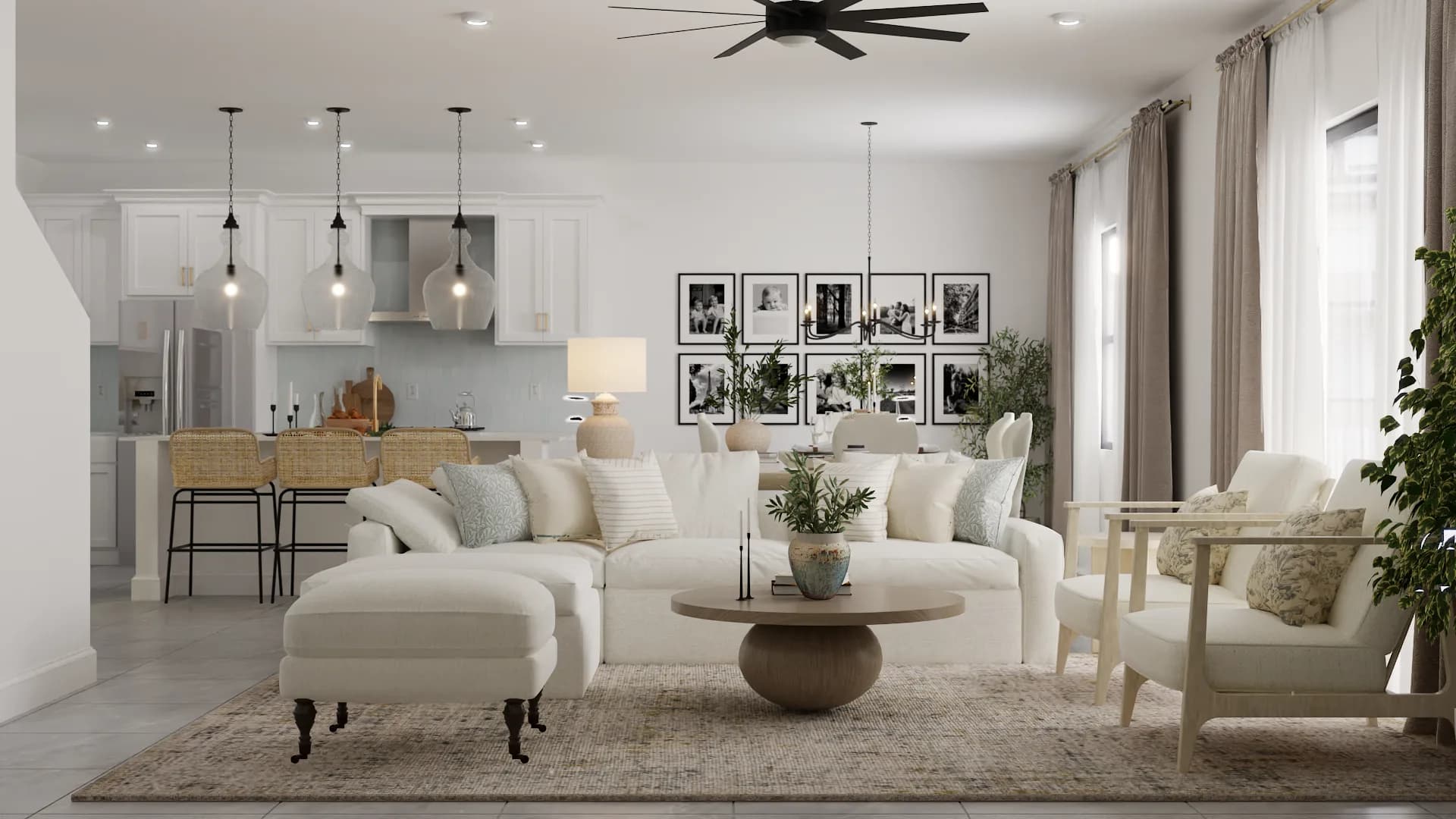Cream sectional with B&W gallery wall and open kitchen behind