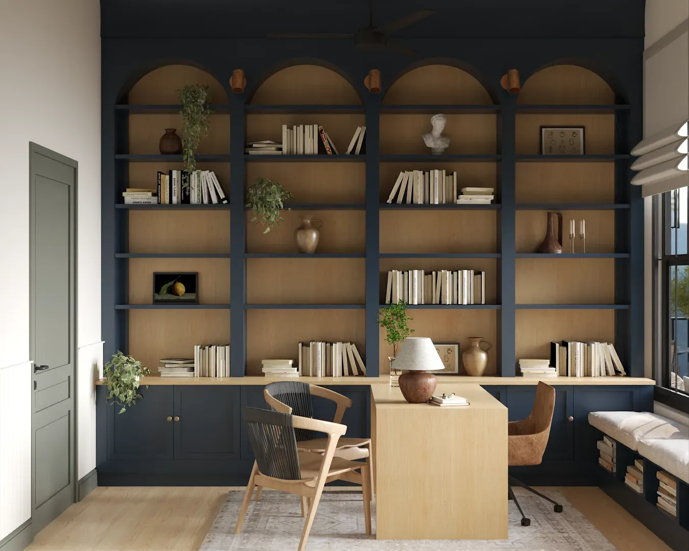 Navy home office with arched bookshelves, oak desk, and woven chairs