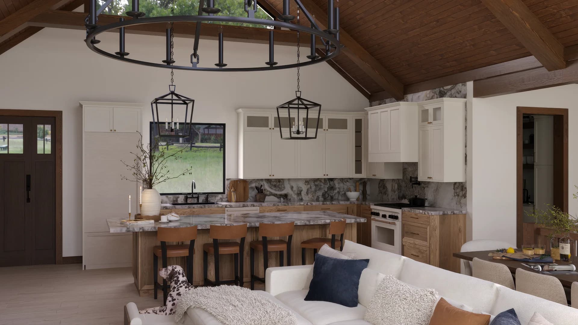 Modern farmhouse kitchen and living area with vaulted wood ceiling, iron chandeliers, calacatta marble island, oak base cabinets, leather counter stools, and cream sectional with Dalmatian dog