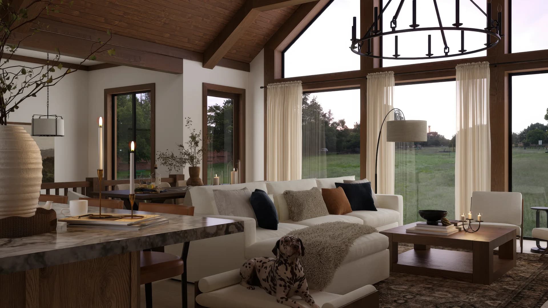 Modern farmhouse living room with vaulted wood ceiling, iron ring chandelier, cream sectional, navy pillows, walnut coffee table, and floor-to-ceiling windows to pastoral landscape by Debora Interiors