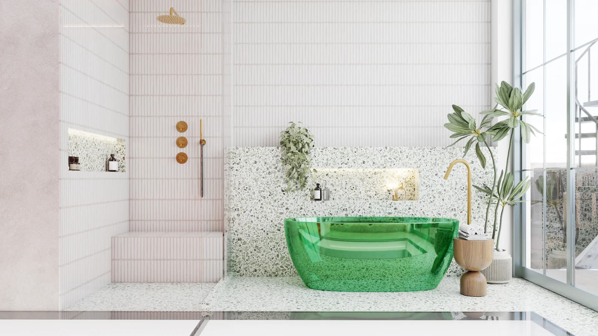 Bathroom with a transparent green resin freestanding bathtub on a terrazzo floor, white vertical subway tile walls, brass rain shower fixtures, built-in niche shelf, and tall tropical plants beside floor-to-ceiling windows