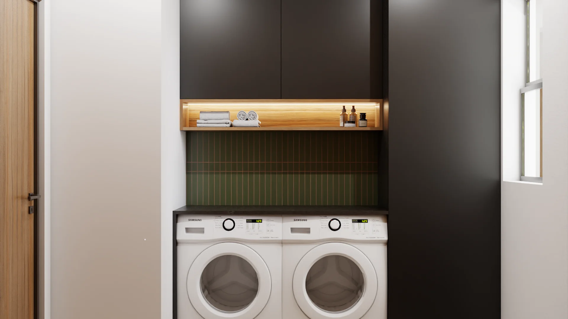 Laundry niche with front-load washer and dryer, green tile backsplash, illuminated oak shelf with towels, and charcoal cabinets