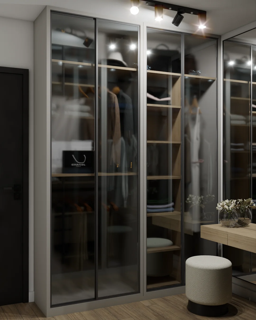 Walk-in closet with smoked-glass doors, integrated drawers, vanity console, and boucle pouf