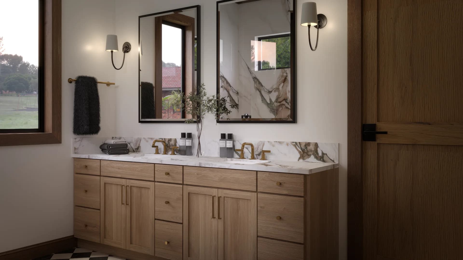 Master bathroom vanity from window side with natural light on calacatta marble countertop, gold veining detail, oak drawers with brass knobs, and garden view through window