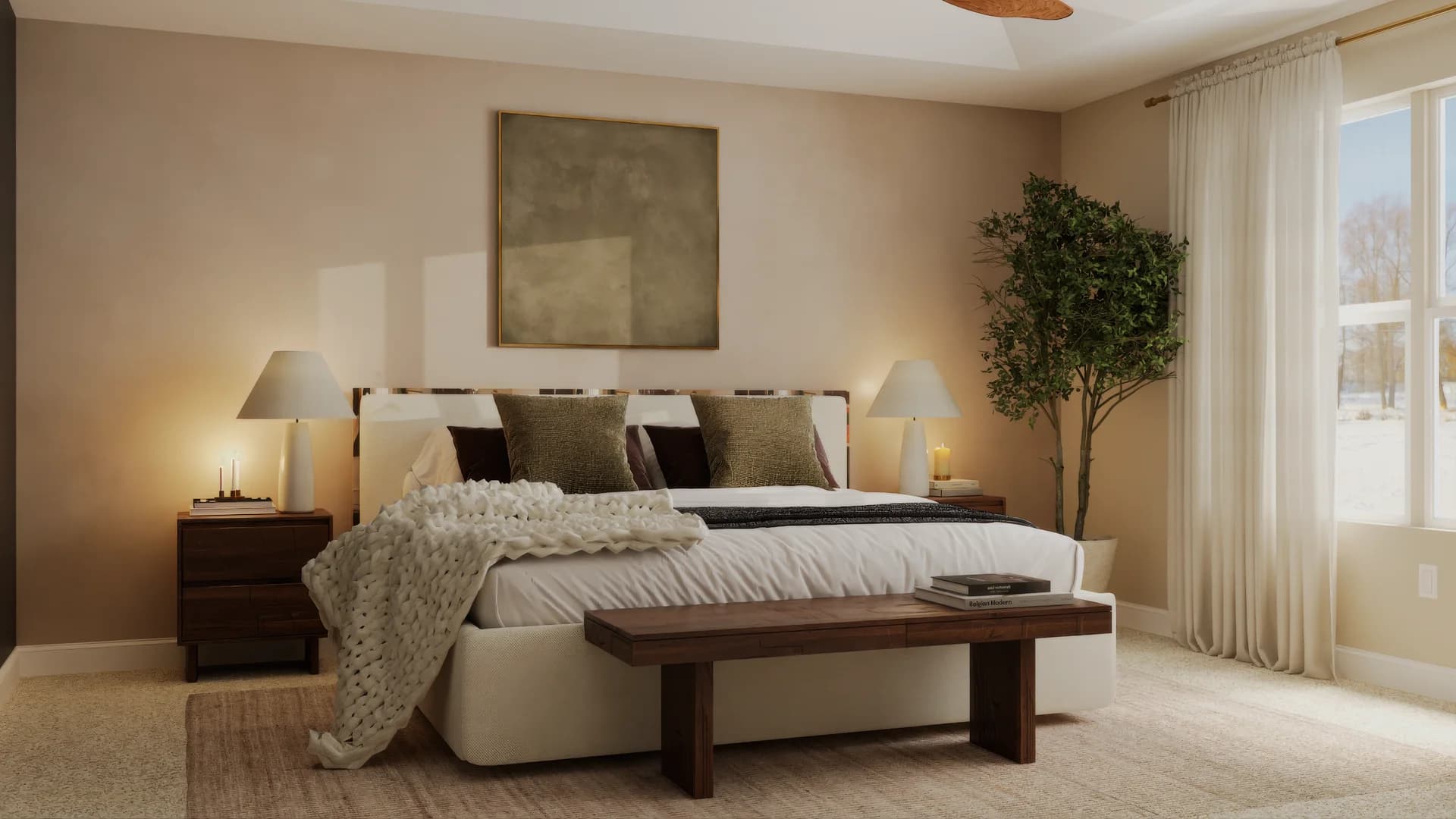 Master bedroom bed-centered view with cream upholstered headboard, olive velvet and dark brown pillows, chunky knit throw, walnut nightstands with warm table lamps, abstract square canvas above headboard, walnut foot bench, sheer curtains, and potted olive tree near window.