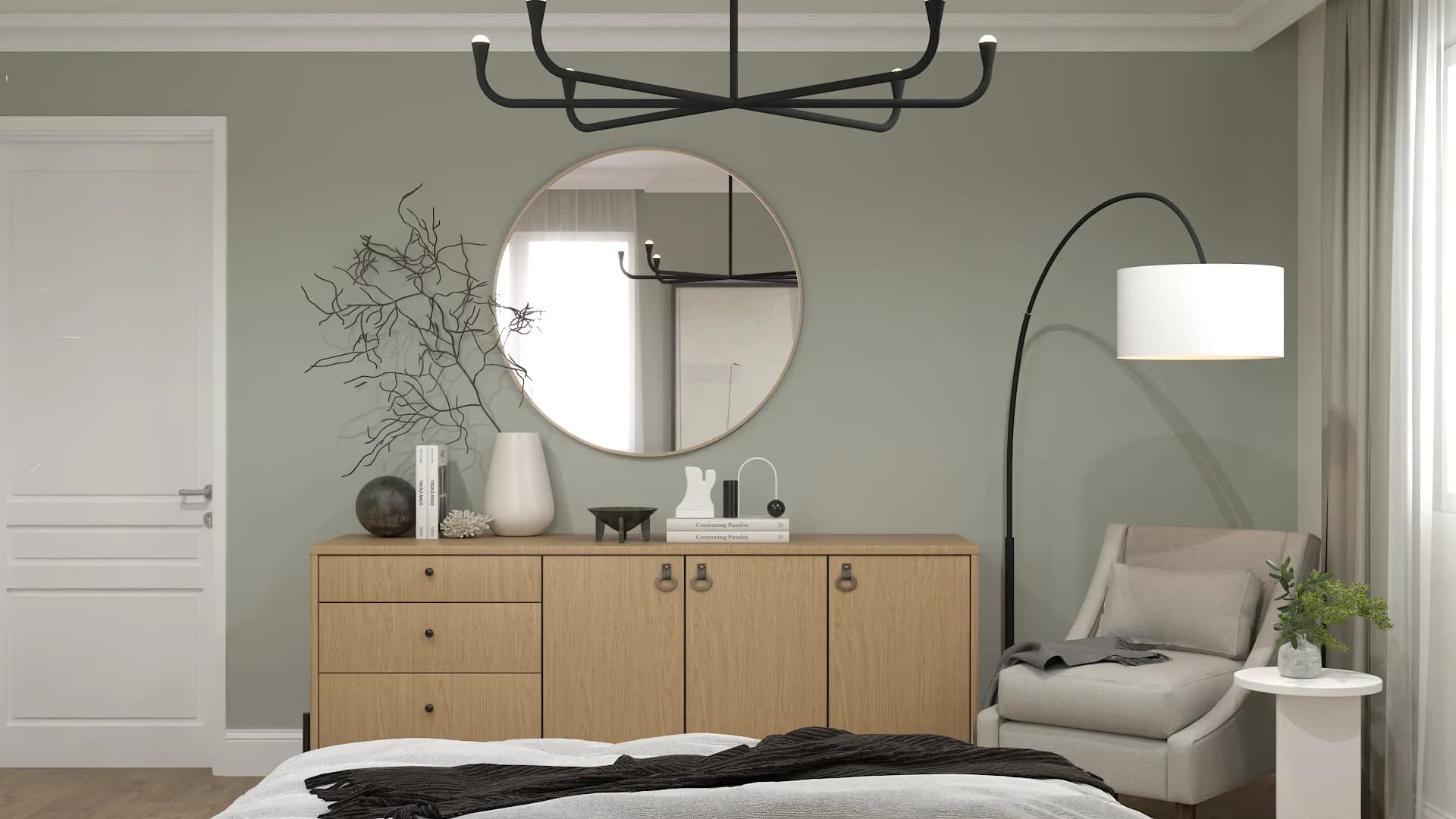 Bedroom with sage green walls, oak dresser, round mirror, and black chandelier