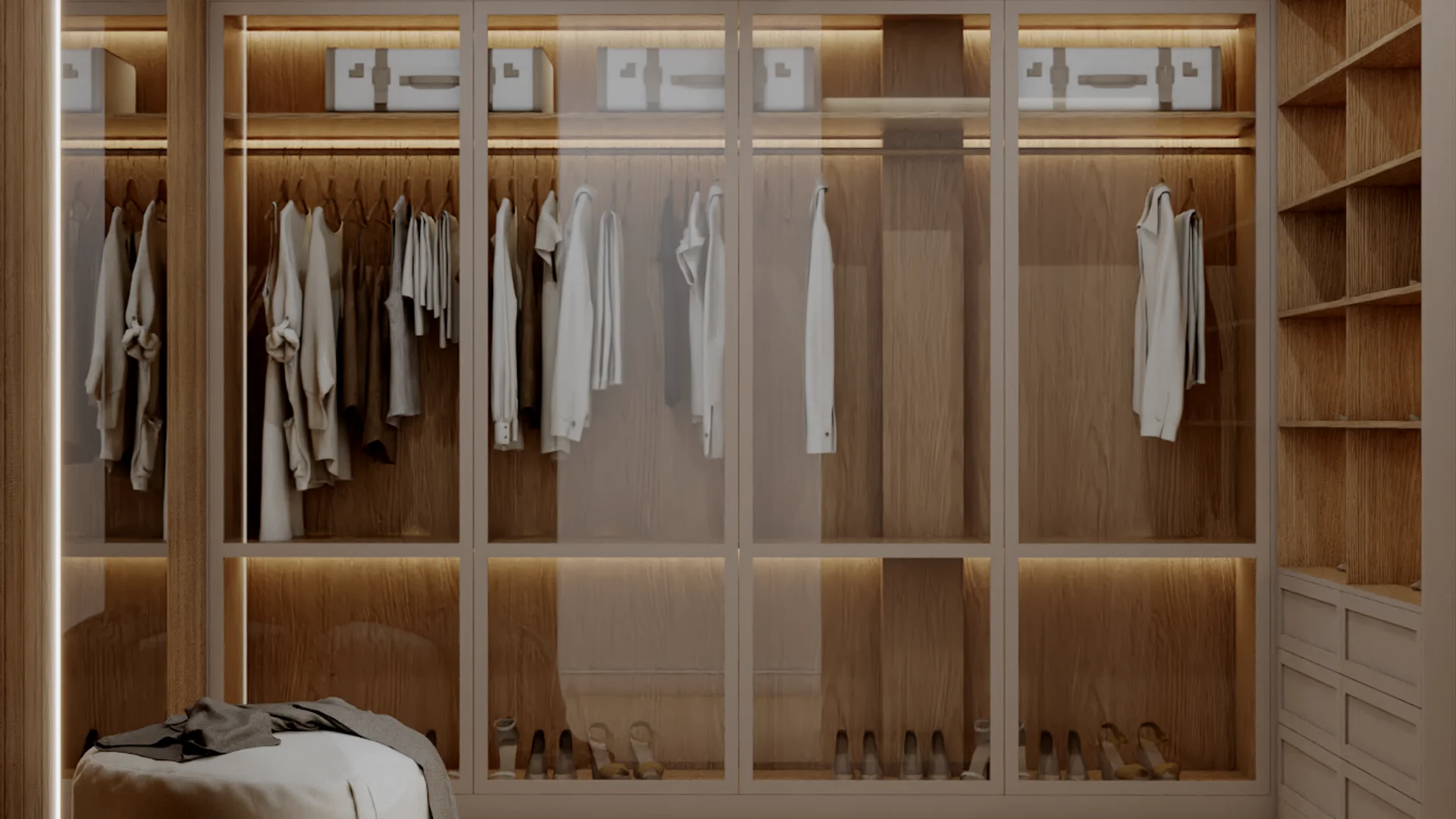 Walk-in closet wardrobe section with glass-front cabinet doors revealing folded clothes inside, oak frame and panel details, a hanging rail section, and LED strip lighting above