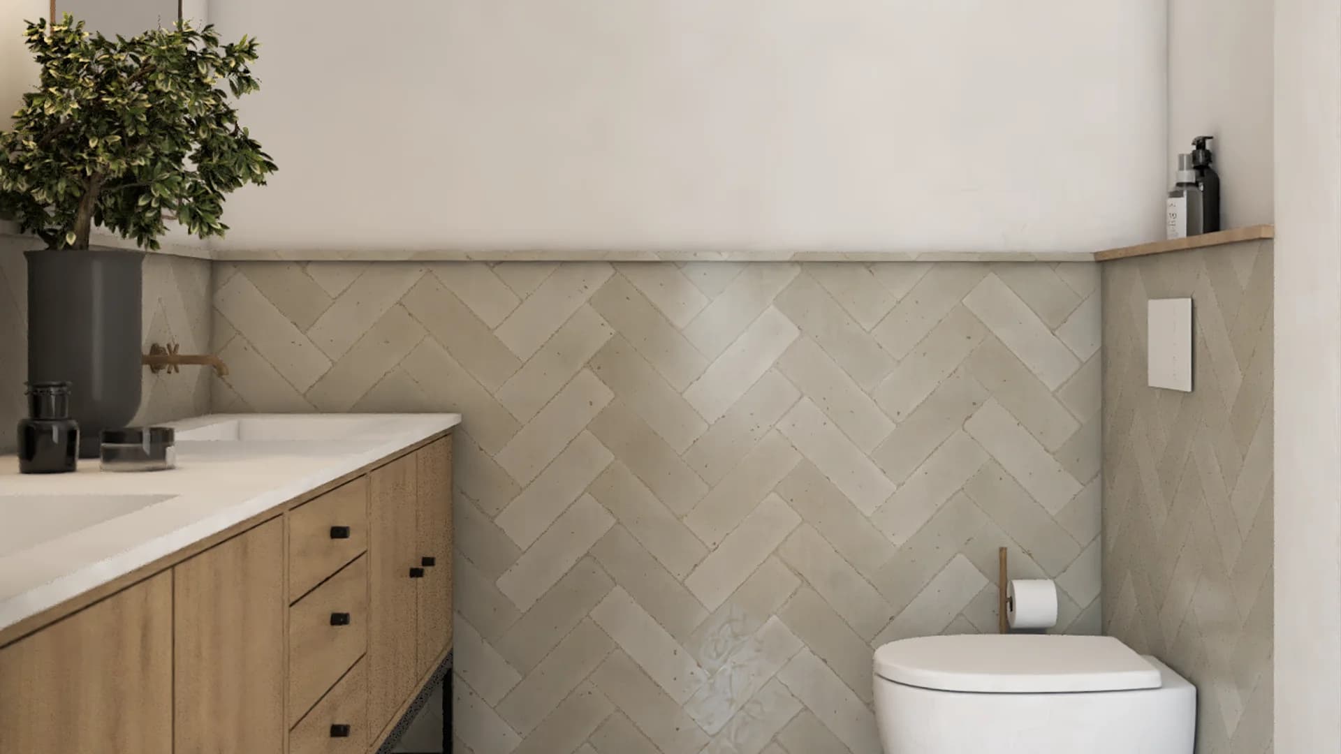 Bathroom with herringbone tile on walls or floors, a wall-hung toilet with a concealed cistern, white and warm neutral palette, oak accents, and black iron hardware throughout