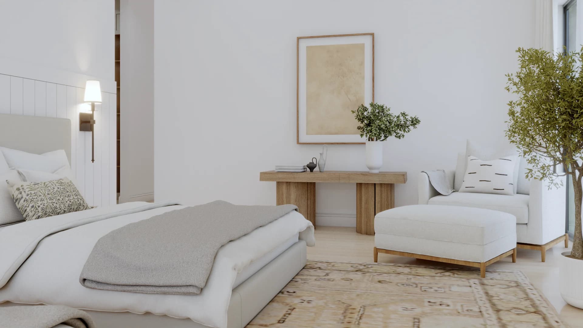 Primary bedroom with an oak console table or dresser against a white wall, a mirror above, warm oak hardwood flooring, neutral bedding, and soft ambient lighting from a table lamp