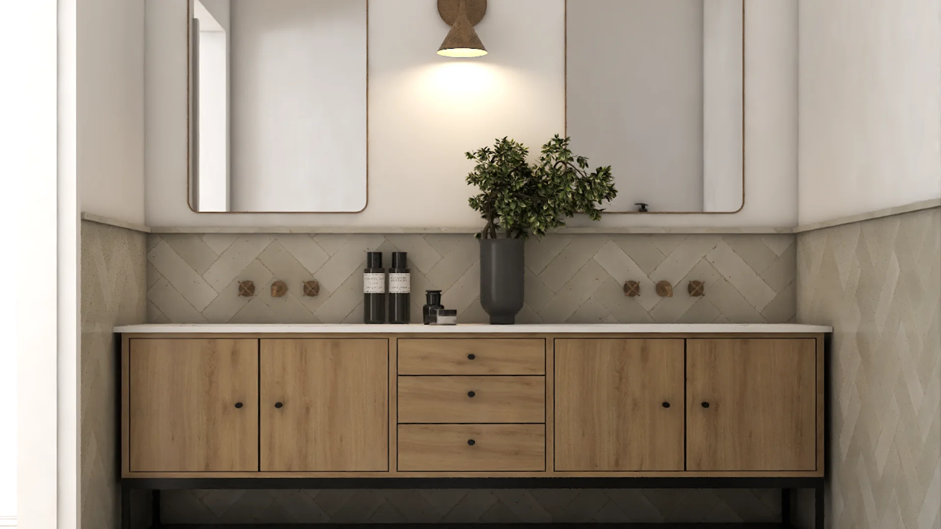 Bathroom double vanity with warm oak cabinet fronts, two undermount sinks, a long countertop, black or gold faucets, two framed mirrors, and a herringbone tile floor below