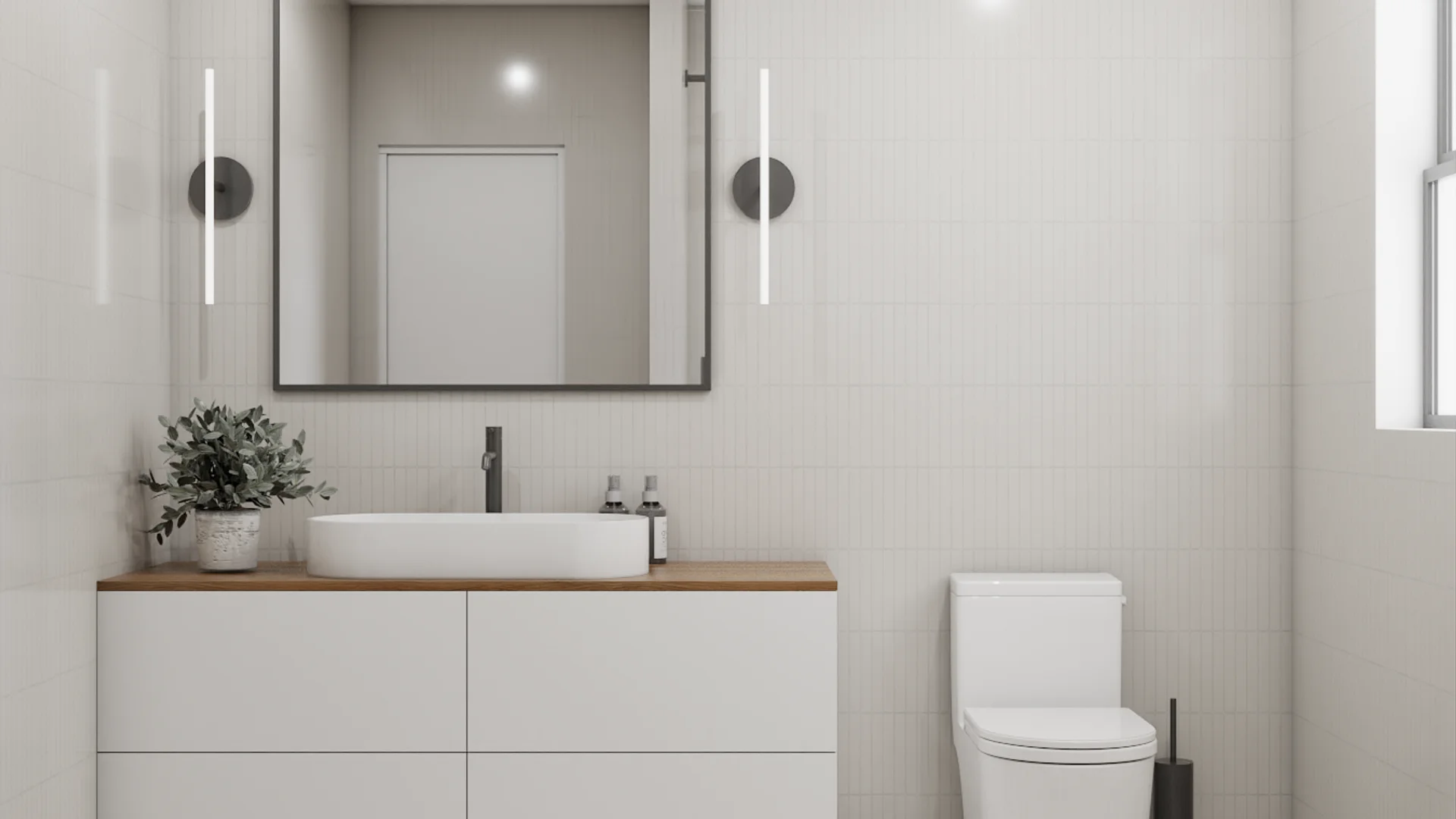Guest bathroom with oval vessel sink, oak vanity countertop, black faucet, subway tile, dark-framed mirror, and wall sconces