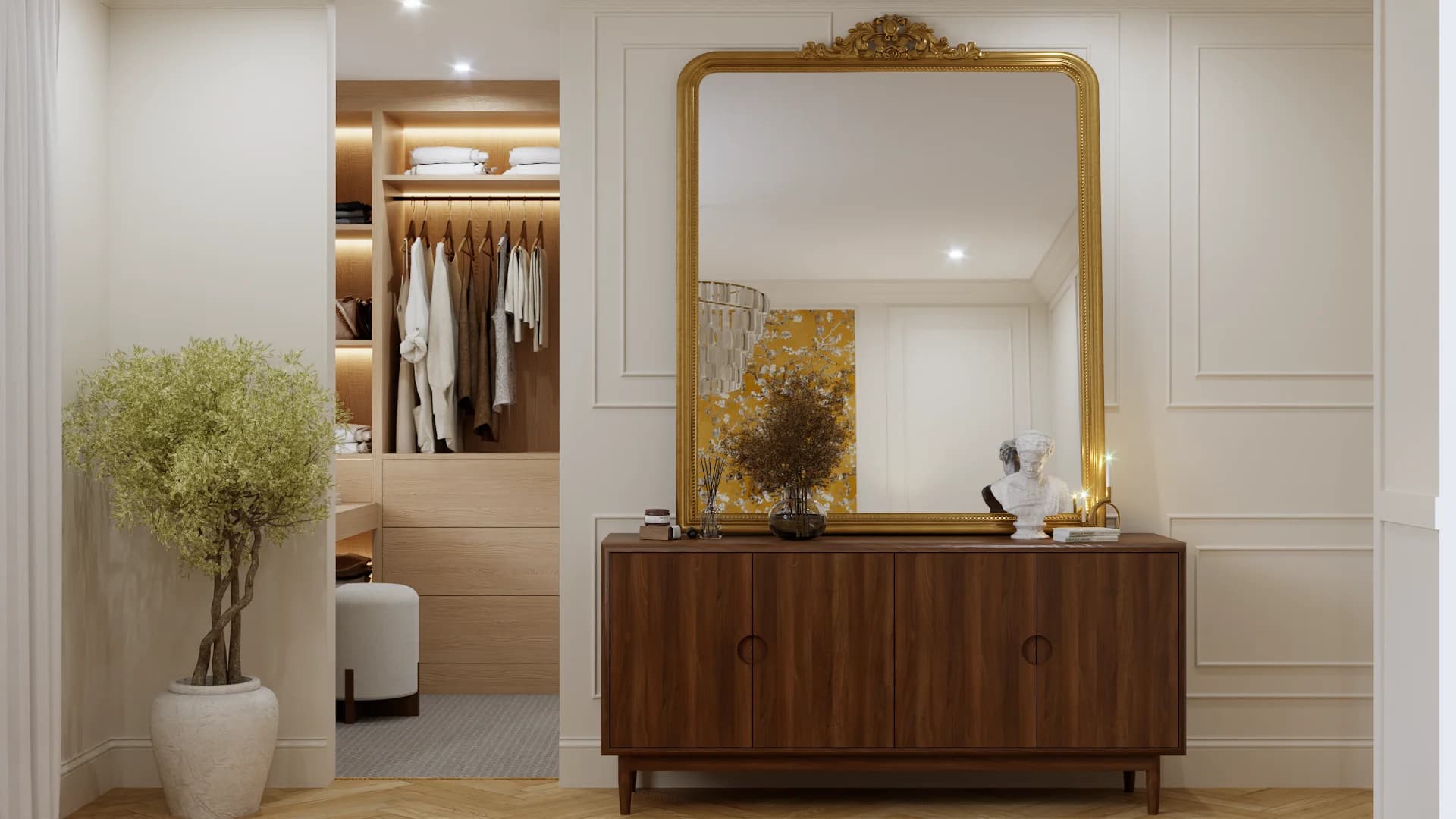 Walk-in closet dressing area with warm oak built-in shelving, hanging rail, and LED strip lighting, alongside a walnut sideboard topped by a gold ornate mirror and classical bust sculpture on white panel walls