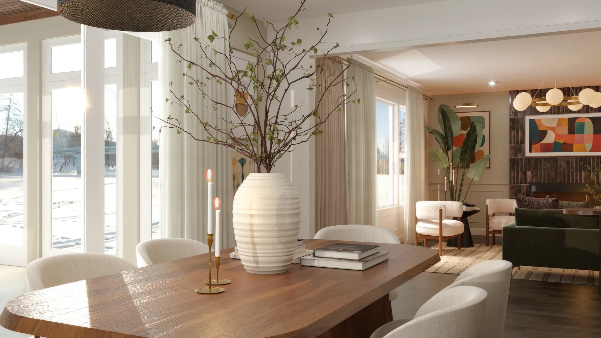 Dining room detail with oval walnut table, white upholstered chairs, oversized white ribbed ceramic vase with bare branching stems, brass taper candle holders, sheer floor-to-ceiling curtains, large windows with garden view, open plan living area visible in background