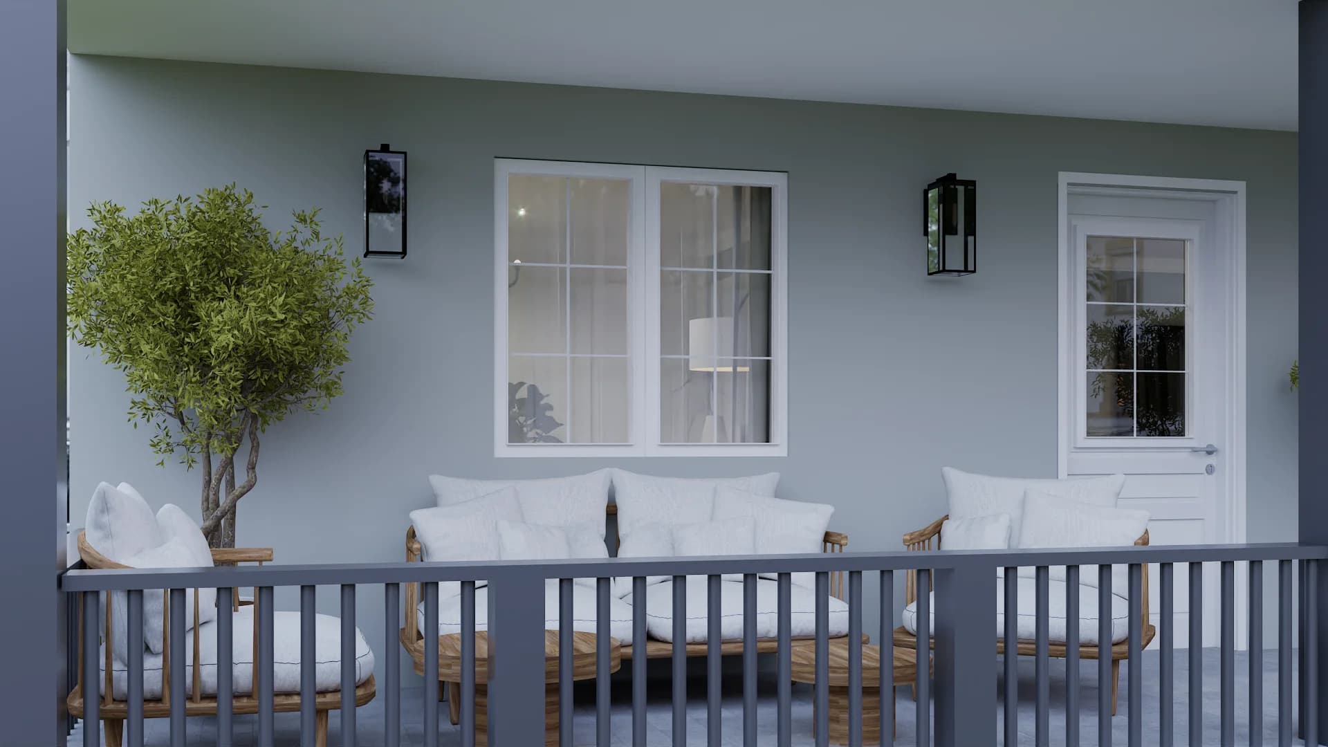 Covered front porch with blue-gray walls, rattan sofas, white cushions, black lantern sconces, and a potted olive tree