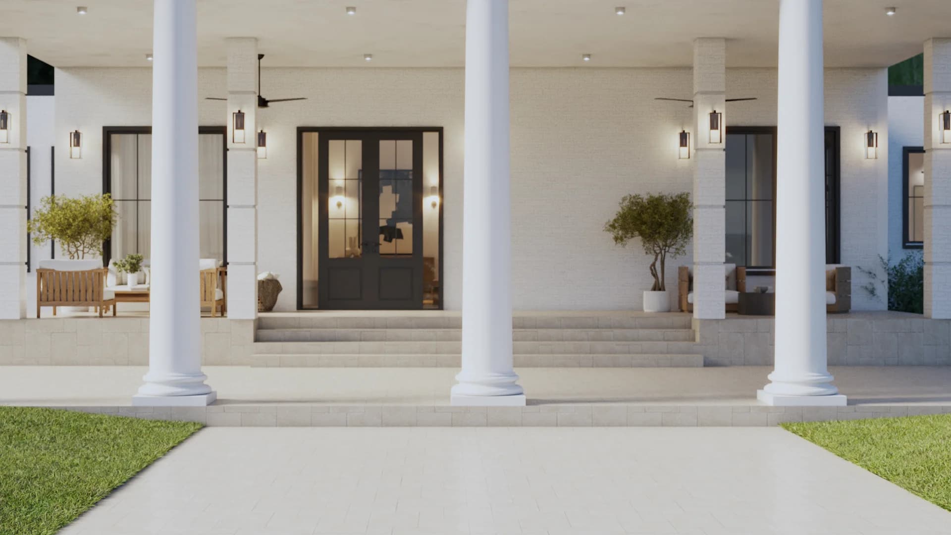 Wide columned front porch with cream brick, dark double entry doors, teak bench seating, black iron lanterns, recessed ceiling lights, and potted olive trees by Debora Interiors