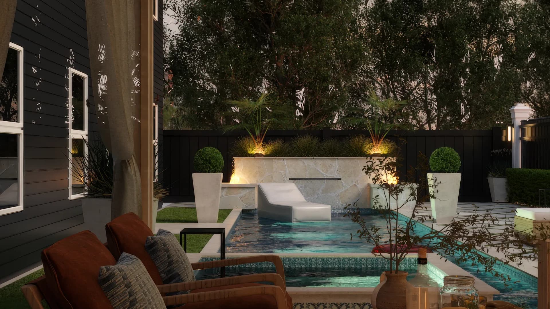 Cabana seating area with cognac leather accent chairs facing the pool and water feature at dusk