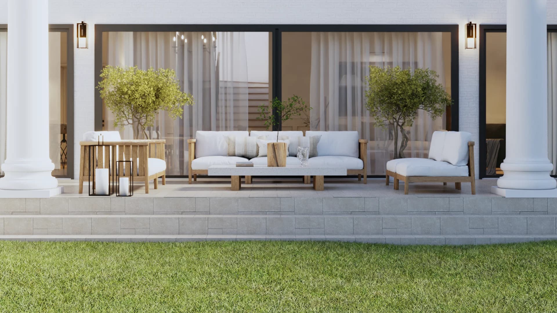Wide covered front porch with teak sofa, lounge chair, and side table with white cushions, sheer curtains, potted olive trees in white planters, and crystal chandelier by Debora Interiors