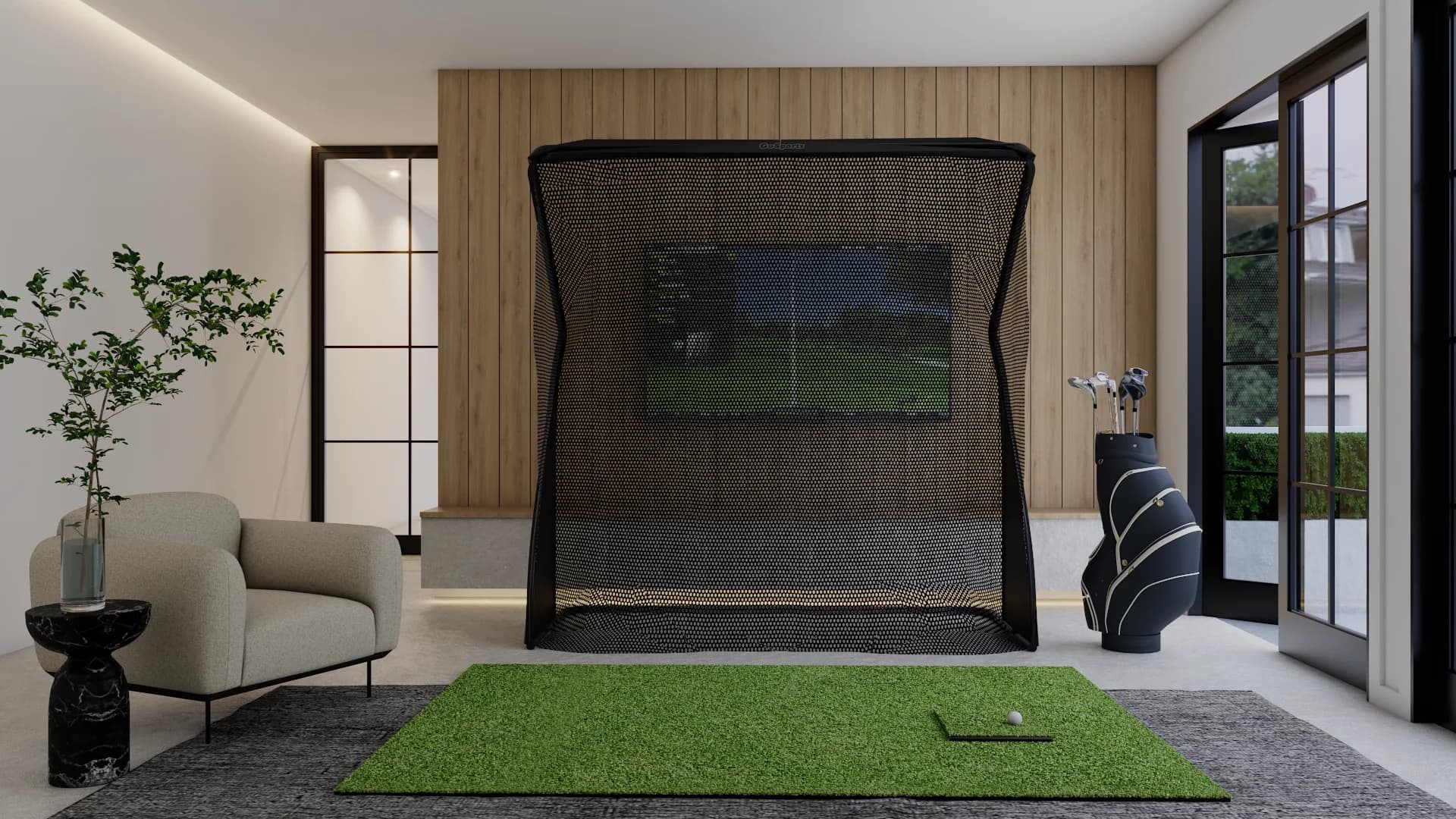 Japandi golf simulator room with black net cage, oak wood slat wall, gray lounge chair, and green turf mat