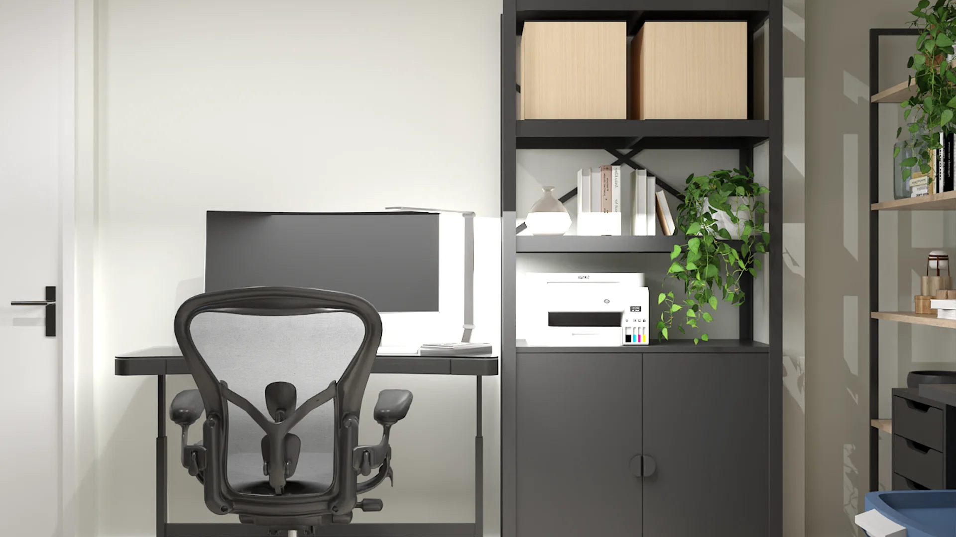 Graphite modular shelving with closed cabinets, mesh task chair, and trailing pothos on upper shelf