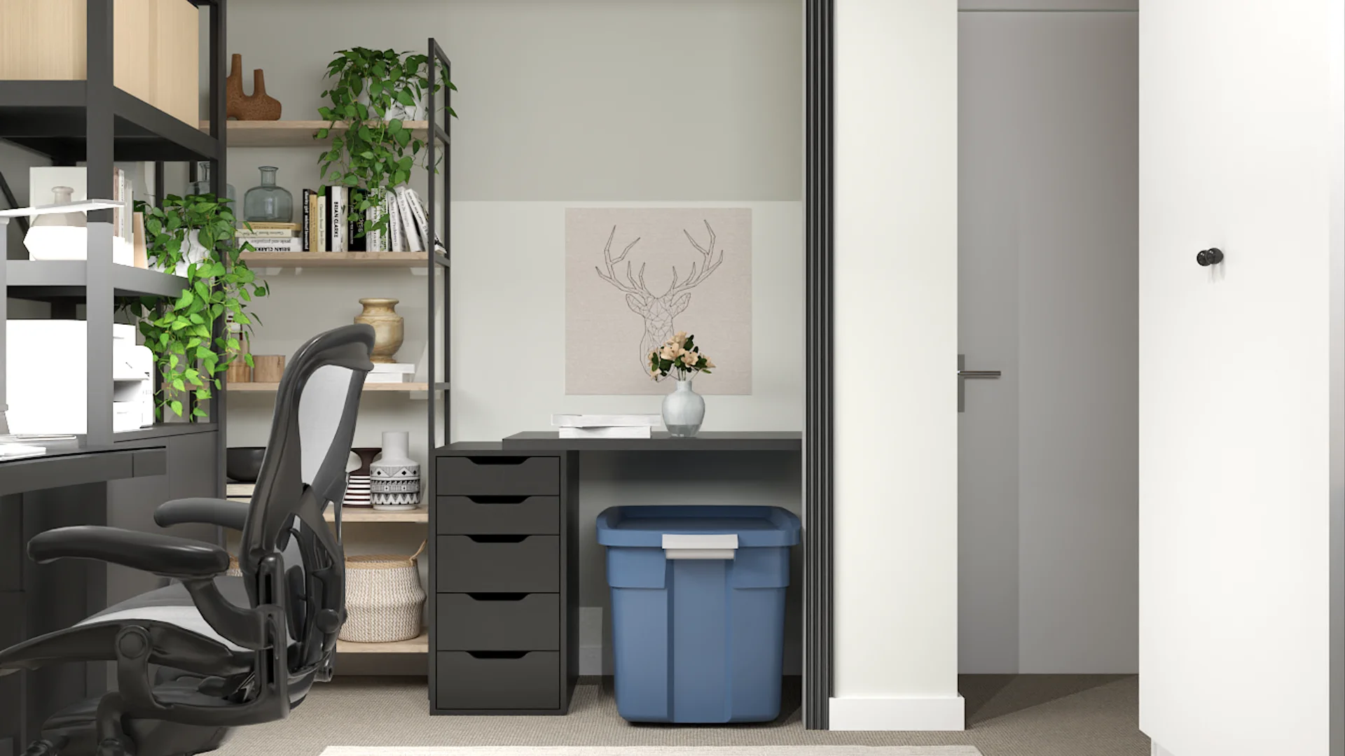 Compact desk nook with dark metal open shelving, glass partition, mesh chair, and trailing plants