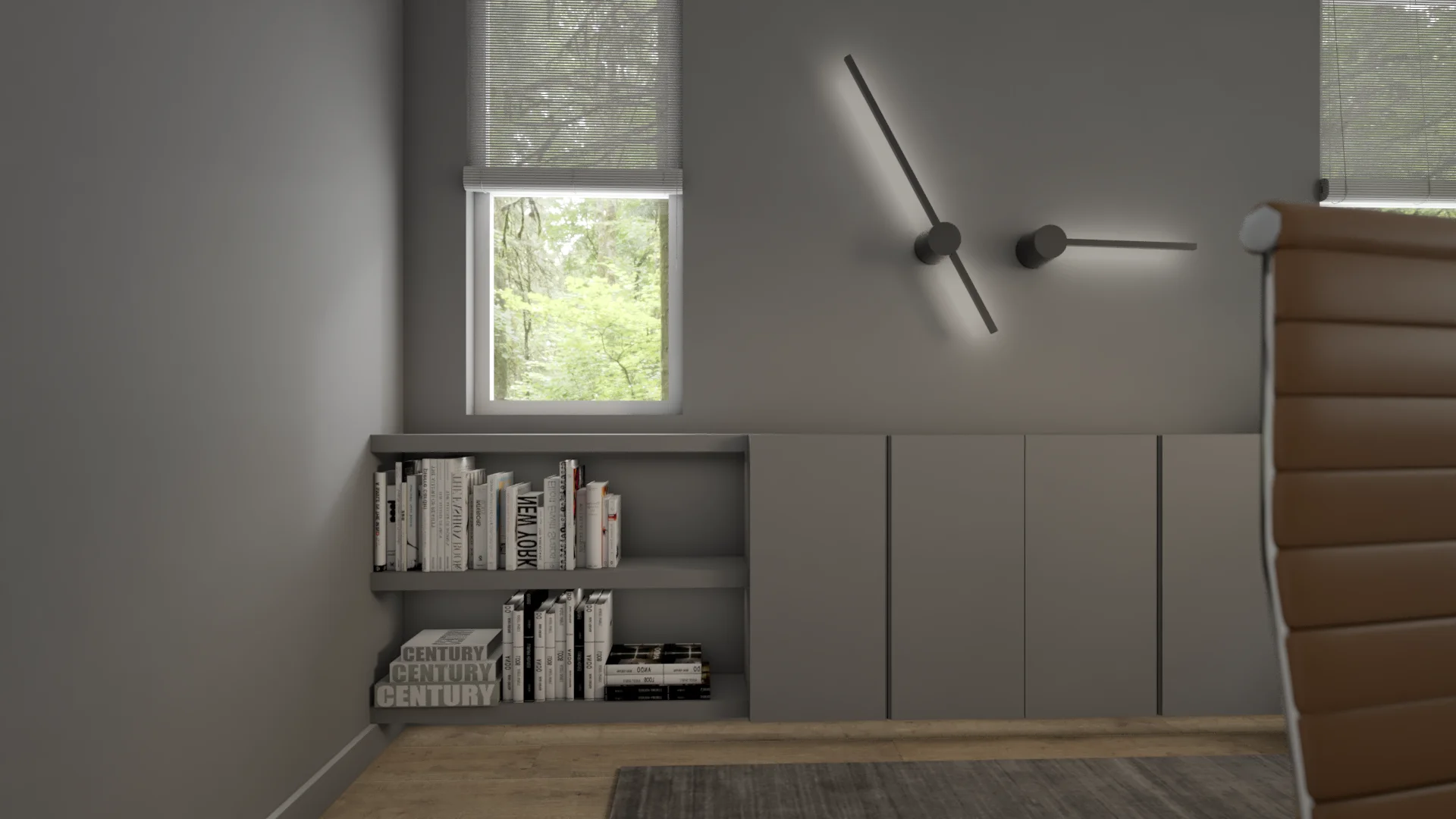 Gray wainscoting with built-in open bookshelves holding design books, two black kinetic linear sconces, and a tan leather Eames chair back in foreground