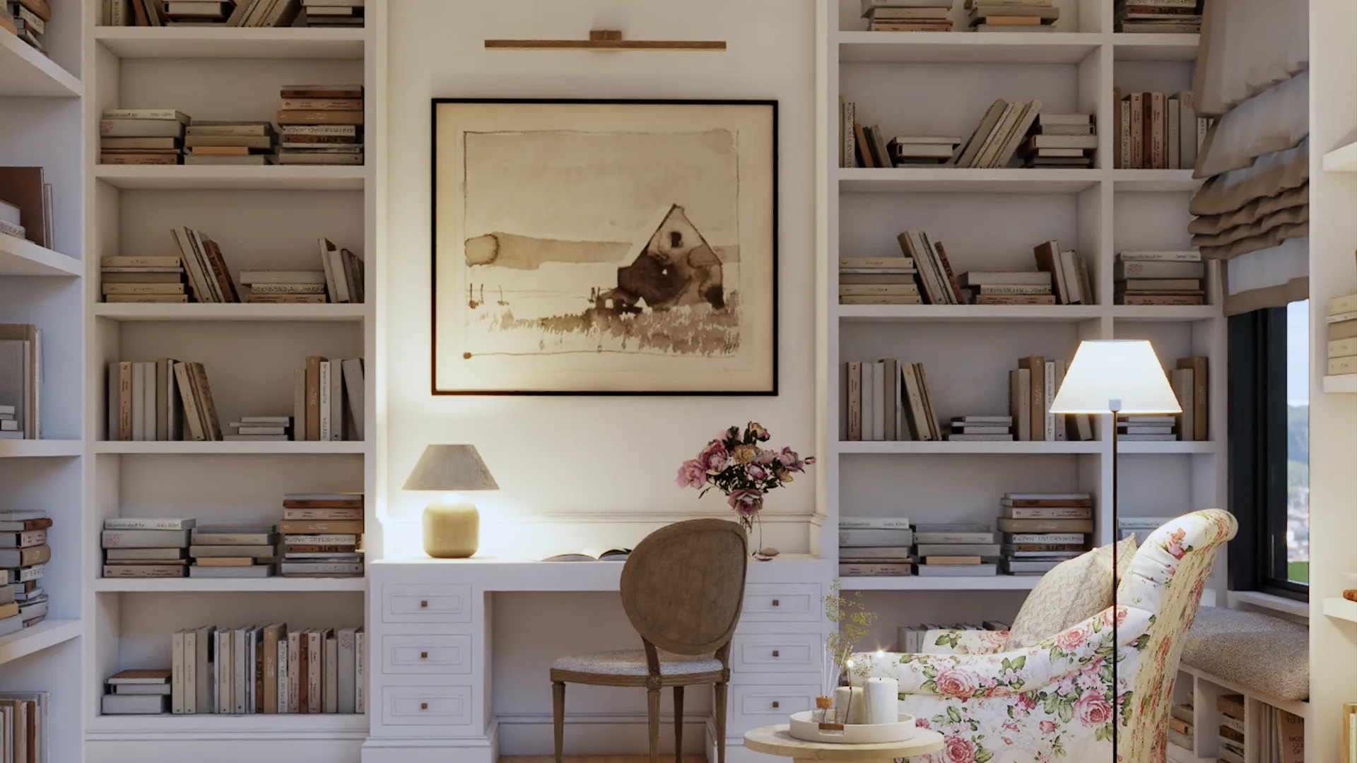Transitional library office with ivory floor-to-ceiling bookshelves, desk niche, brass picture light, carved wood chair, and floral reading chair by Debora Interiors