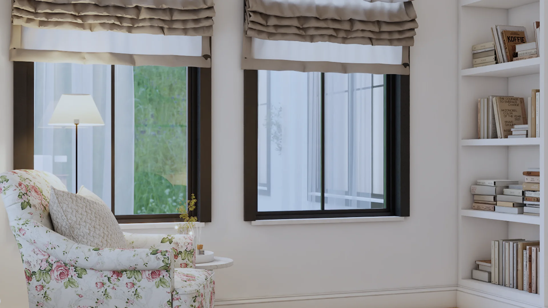 Transitional reading office nook with white open bookcase, floral rose armchair, black-framed windows with ruffled Roman shades, brass floor lamp, and round ivory side table by Debora Interiors