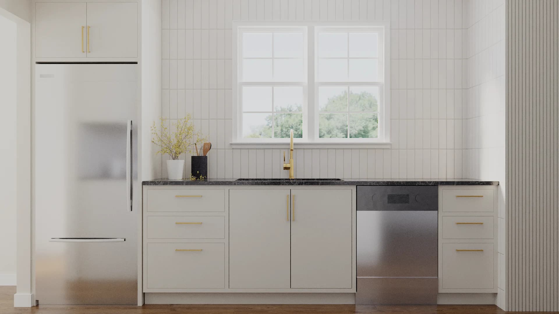 White shaker kitchen with vertical white tile backsplash and brass hardware over black stone counter.