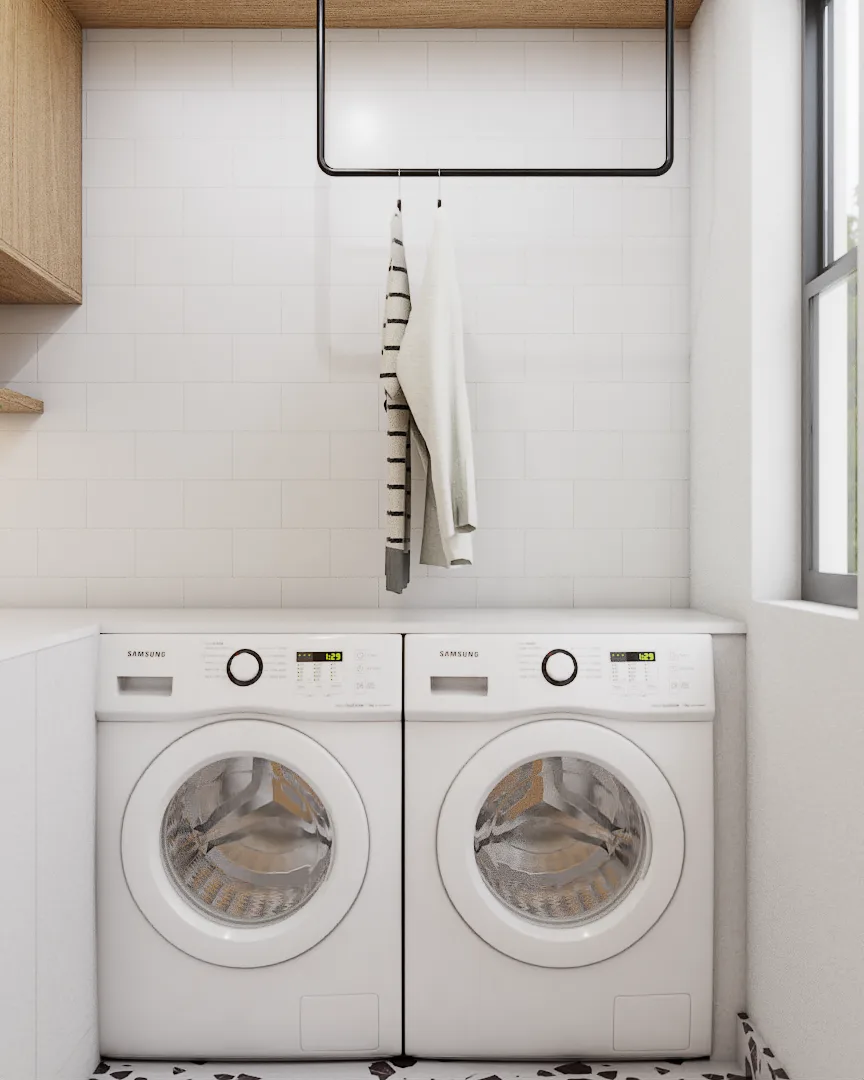 Side-by-side Samsung front-load washer and dryer below white countertop with black ceiling drying rack