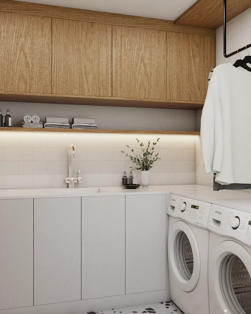 Laundry room with warm oak upper cabinets, white flat-panel lower cabinets, undermount sink, and terrazzo floor tile