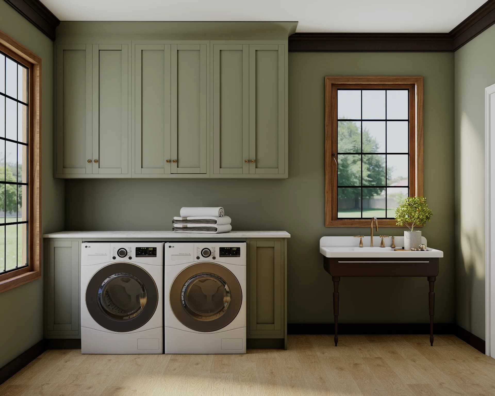 Sage shaker laundry room with vintage console sink, brass bridge faucet, and side-by-side front-load washer and dryer