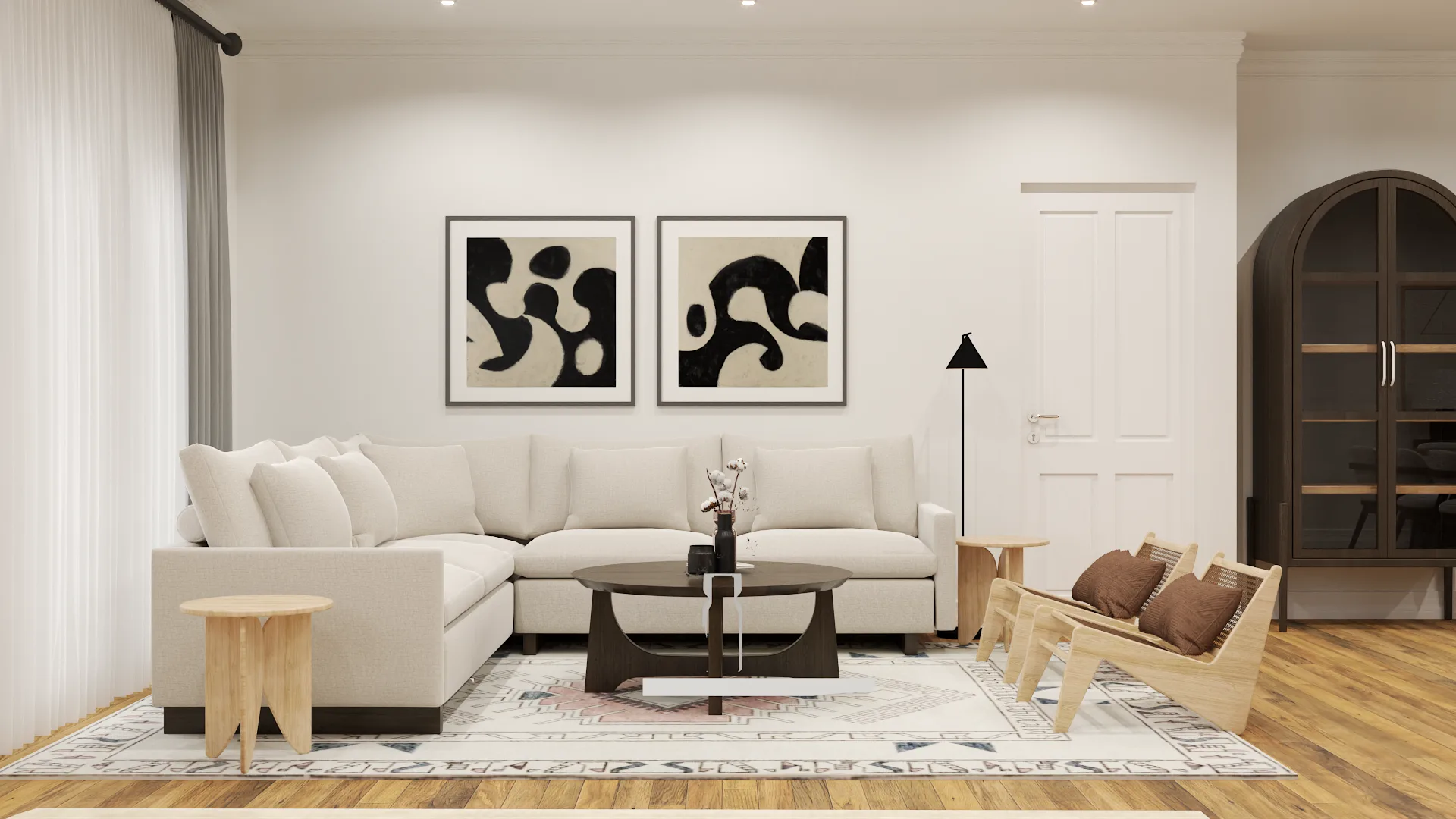 Cream sectional sofa facing bold black abstract prints with arched display cabinet, rattan chairs, and natural oak floors