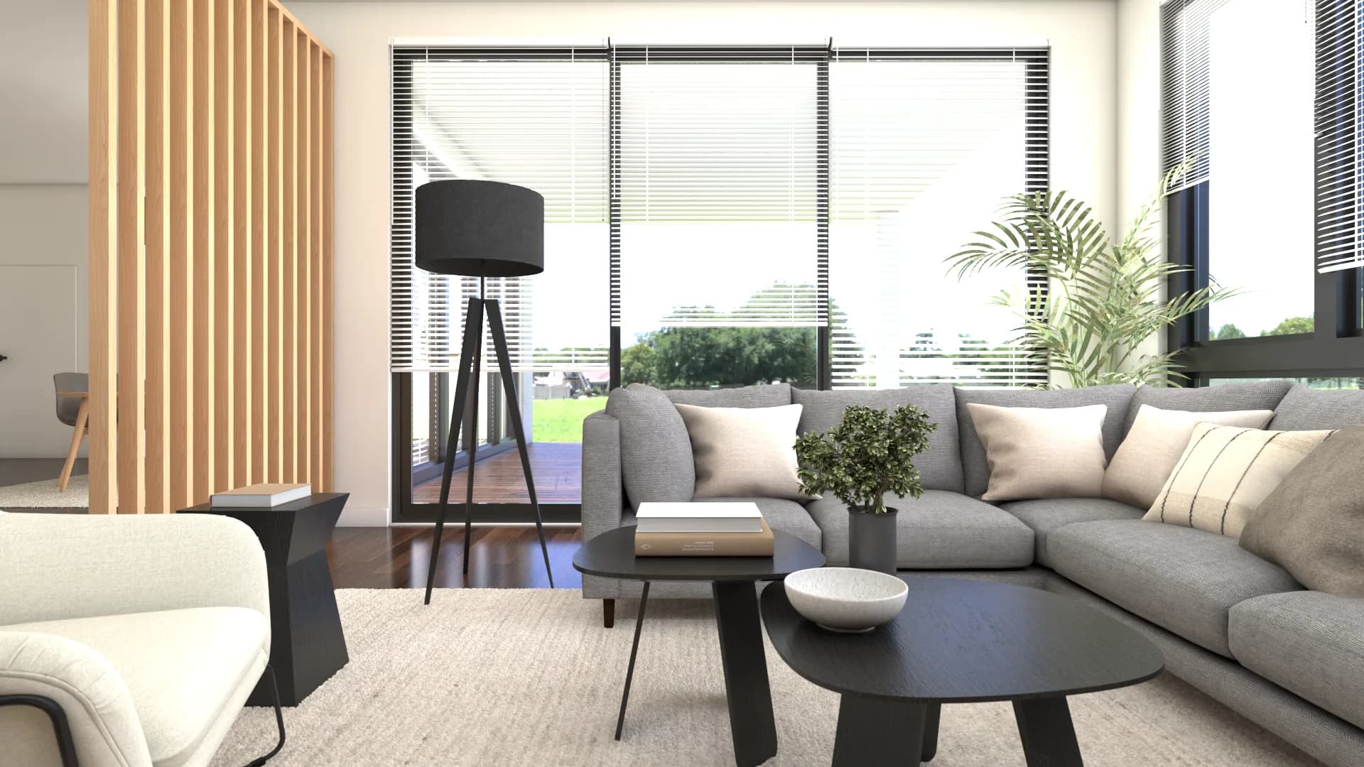 Close view of the gray corner sectional sofa with throw pillows, black tripod lamp, and floor-to-cei