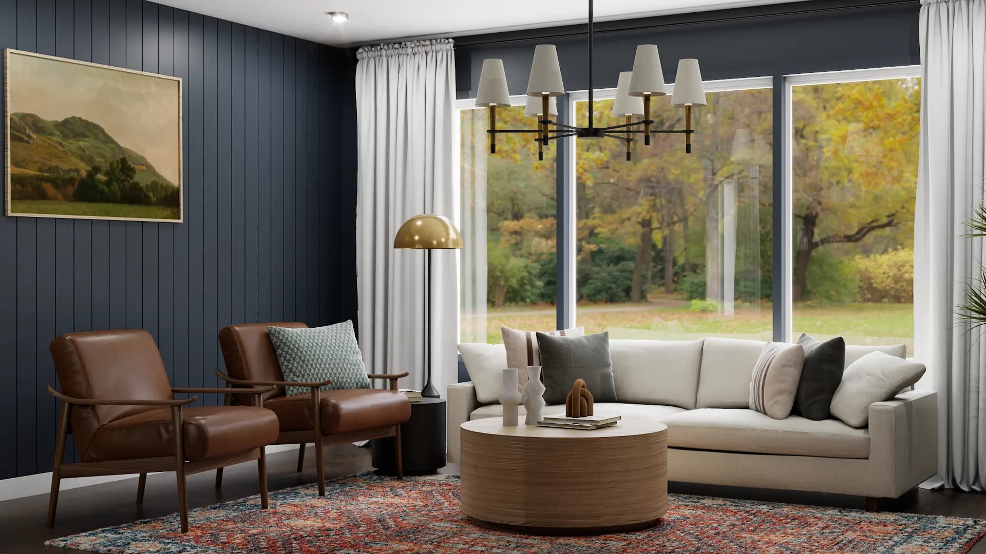 Cream curved sofa centered under brass chandelier with floor-to-ceiling windows showing fall foliage and Persian rug