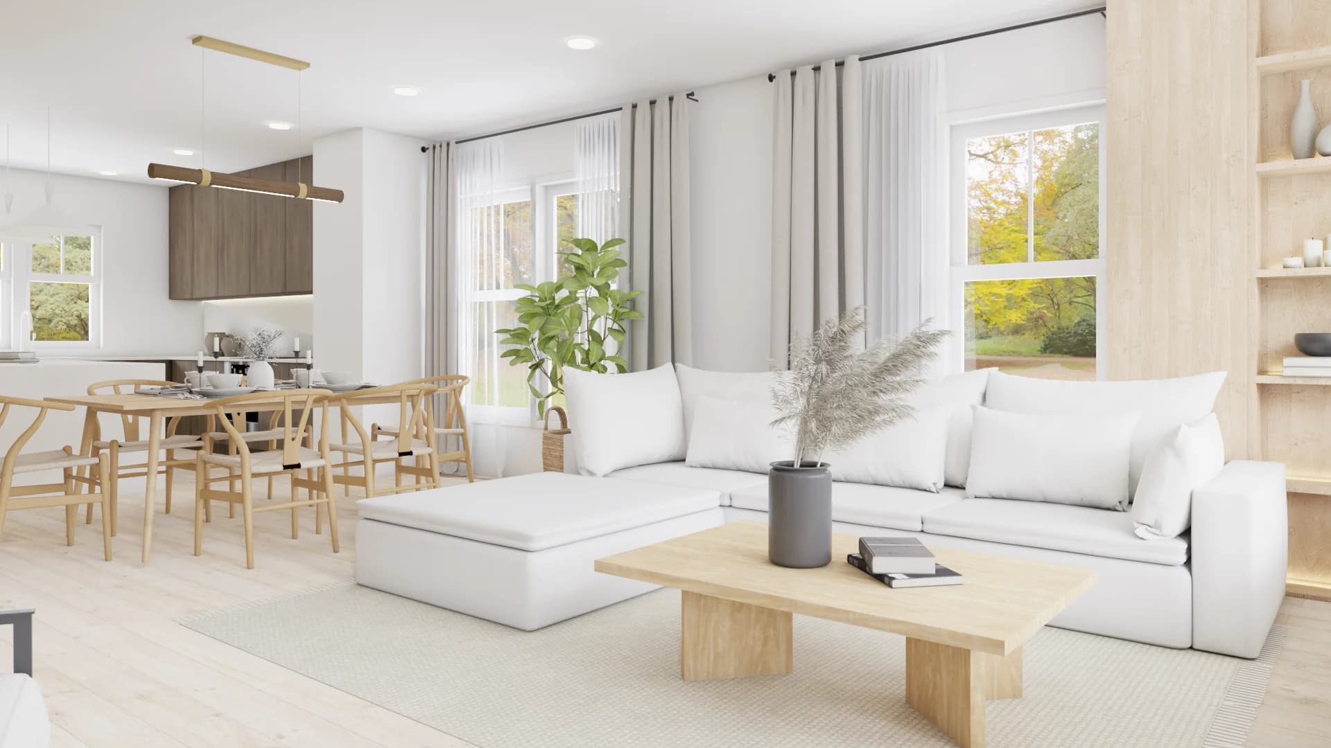Open plan view of white sectional sofa with oak dining table, wishbone chairs, and kitchen beyond