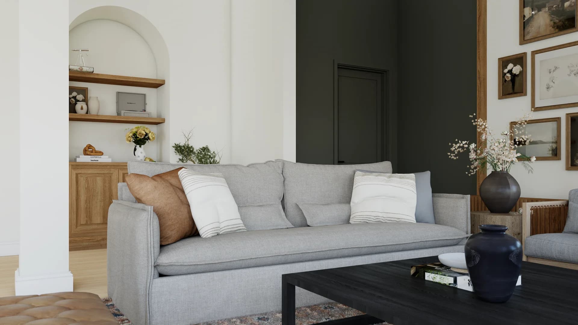 Living room with deep olive accent wall, white arched built-in niche with oak shelves, gray linen sofa, navy ceramic vases, and brass accents