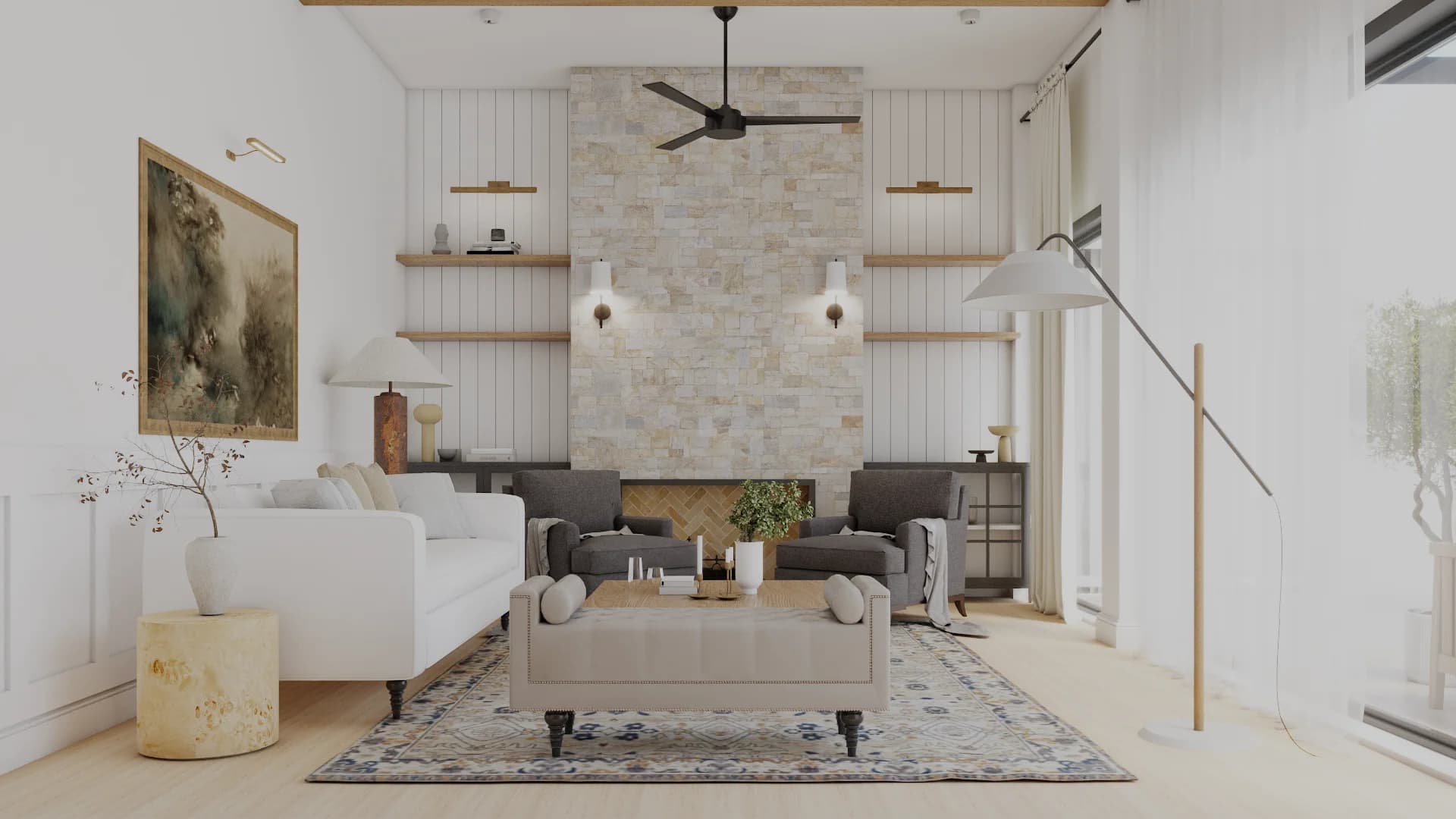 Transitional living room with sandstone fireplace column, white shiplap, floating oak shelves, white sofa, nailhead ottoman, and black ceiling fan by Debora Interiors