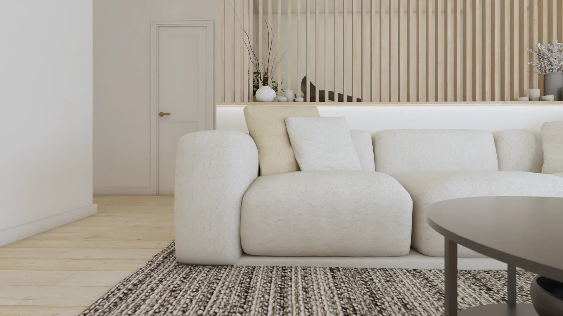 Close-up of white boucle sofa arm with cream cushions, textured rug, and oak slat accent wall