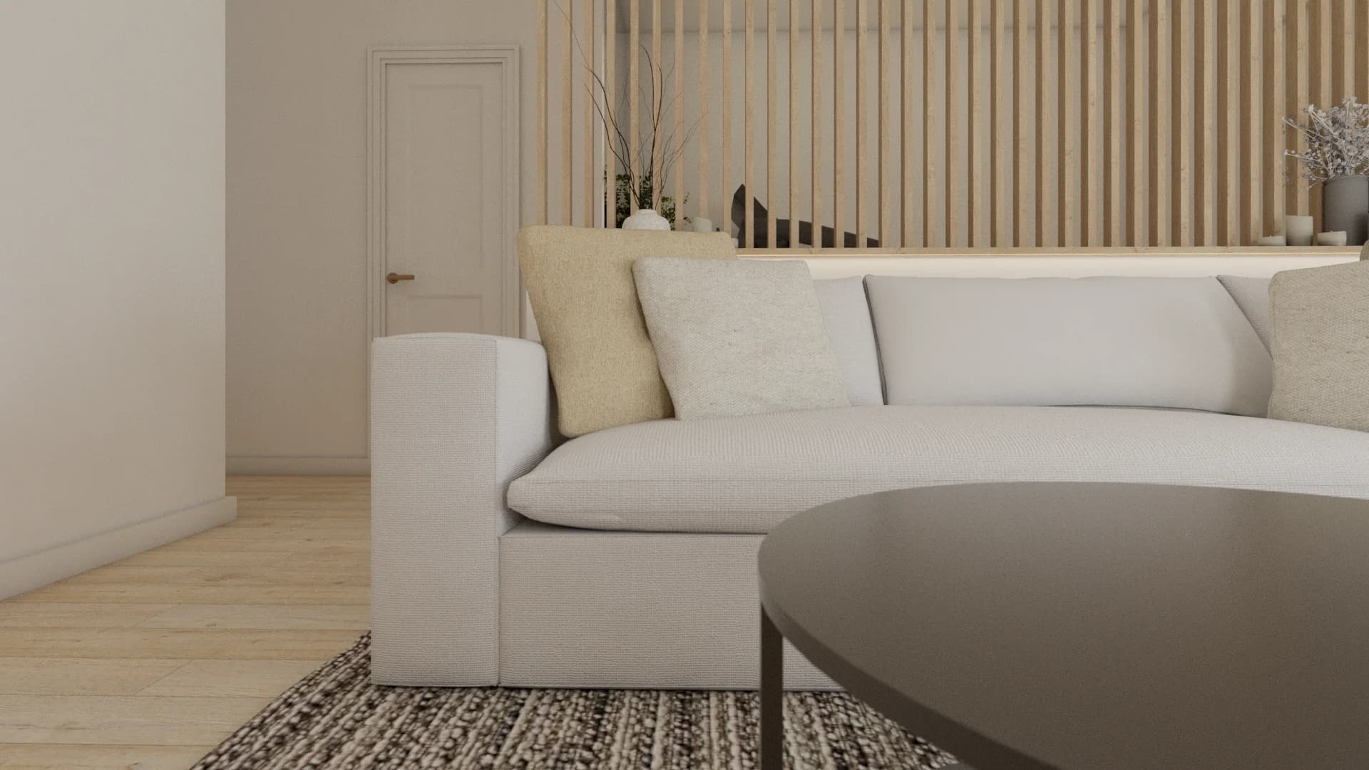 Detail of cream sofa arm and neutral cushions against vertical oak wood slat accent wall