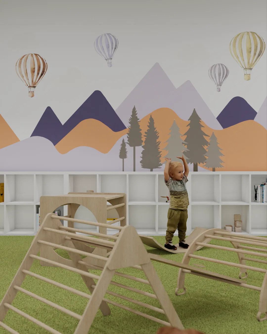 Mountain mural wall with purple and orange peaks, hot air balloons, Pikler triangle climbers