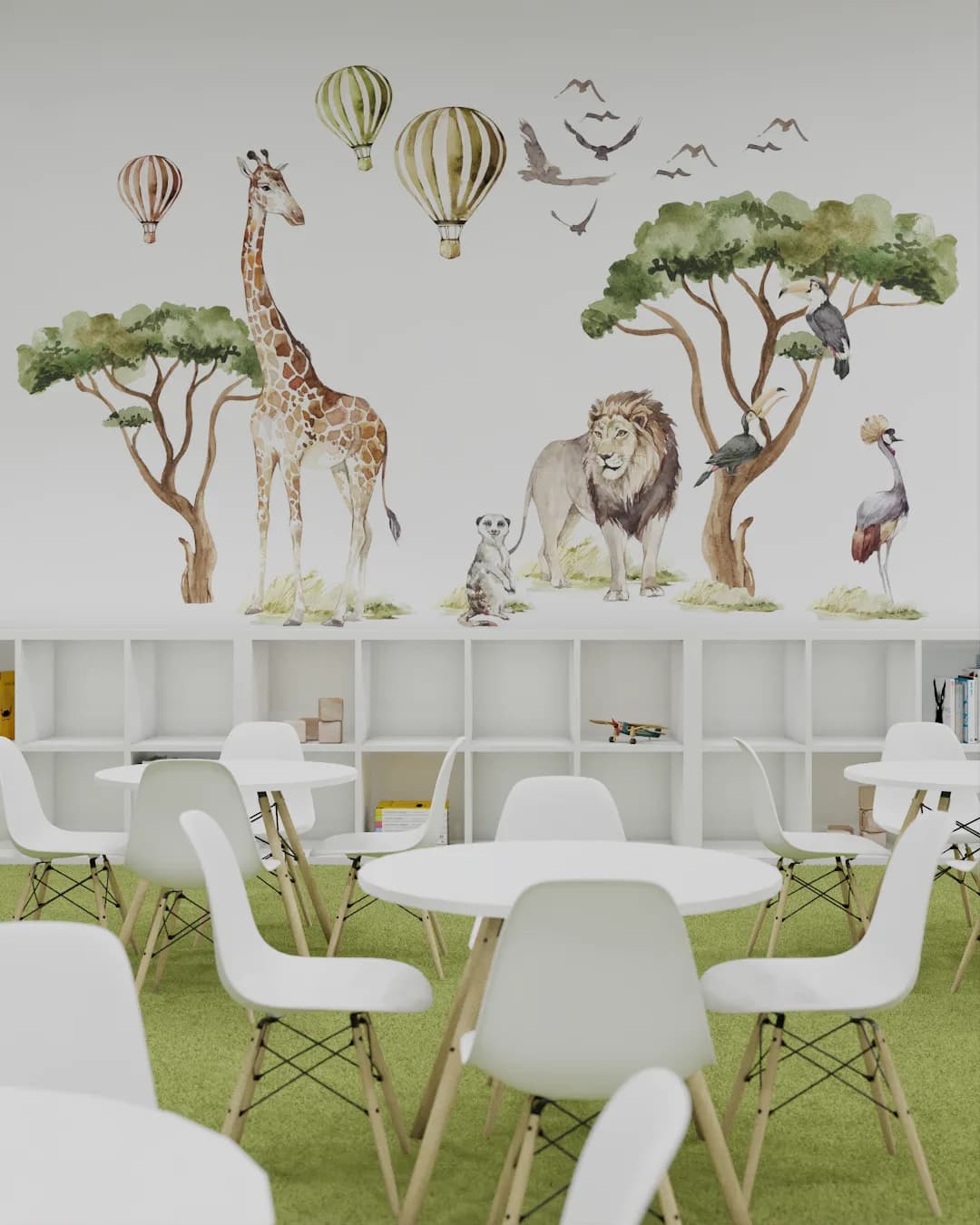 Safari mural wall with Eames tables and chairs on green turf, cubby divider in foreground