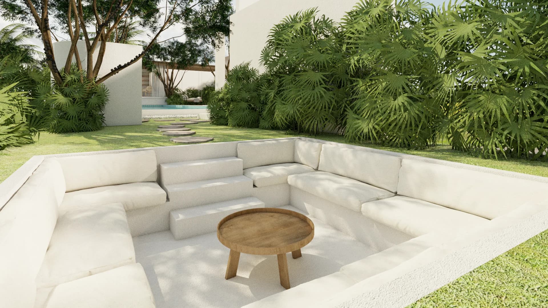 Sunken conversation pit with white built-in cushions and round teak coffee table surrounded by tropical palms