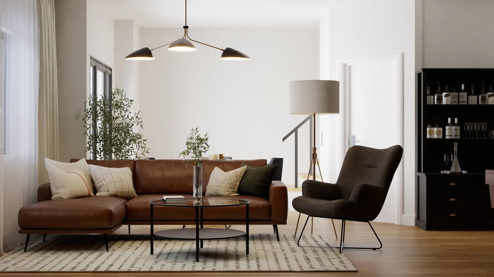 Cognac leather sectional with dark wingback chair, round black coffee table, and brass floor lamp