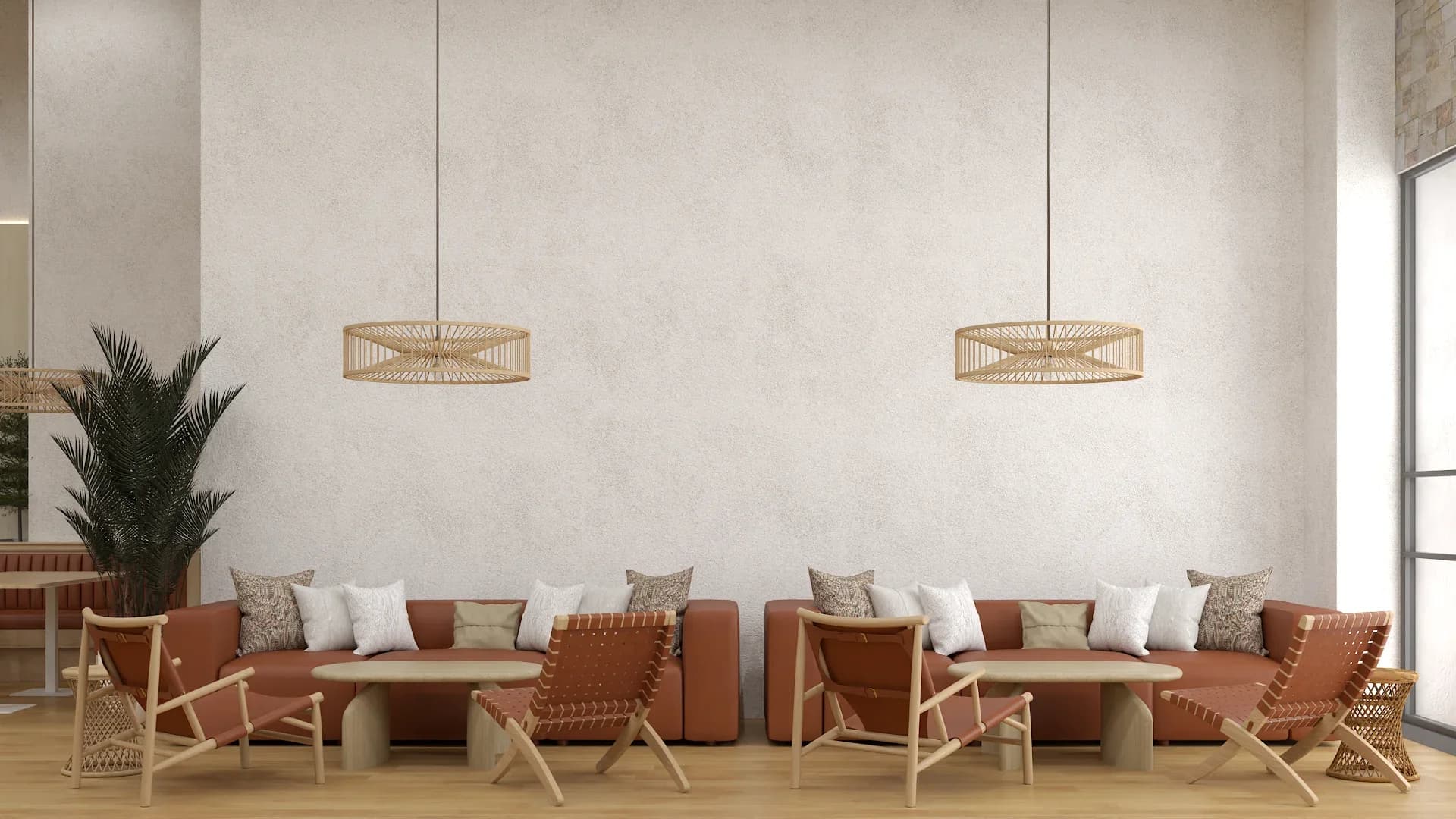 Terracotta leather banquette seating with white and patterned throw pillows along a plastered cream wall, paired with natural wood woven accent chairs and small round concrete side tables beneath two open-weave rattan drum pendant lights on light oak flooring