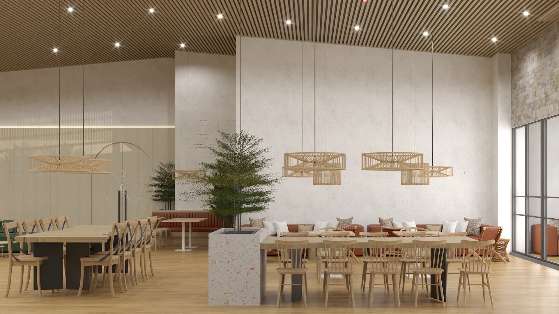 Dining area with slatted wood ceiling, three open-weave rattan drum pendant lights suspended over a long communal table with light wood chairs, terracotta leather banquette with white cushions, terrazzo counter island, decorative pine tree, and a woven fan-style wall light on the left